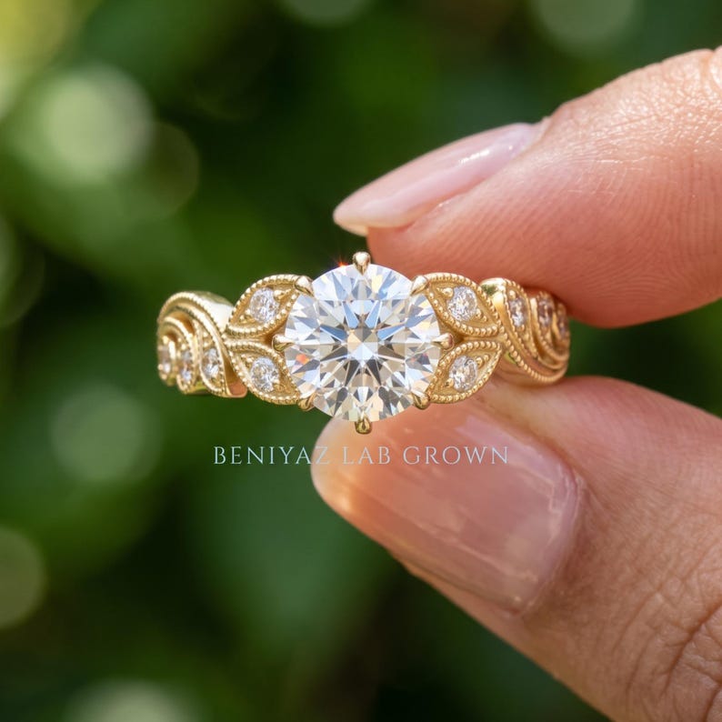 Detailed hand shot of a yellow gold engagement ring with a round lab grown diamond center stone and shimmering accent stones, photographed against green foliage
