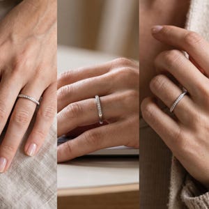 Stackable wedding band worn on hand, showing a slim minimalist 2mm design paired naturally as bridal jewelry.
