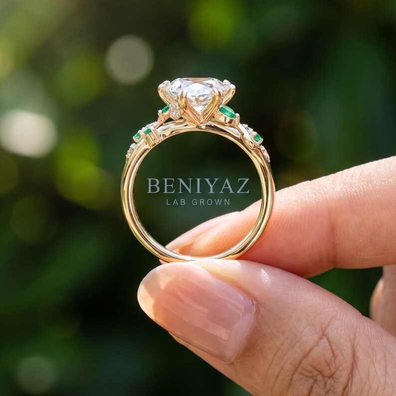 Rear view of the rose gold vine engagement ring held between fingers, showing the openwork shank and elevated Dutch marquise centre setting.
