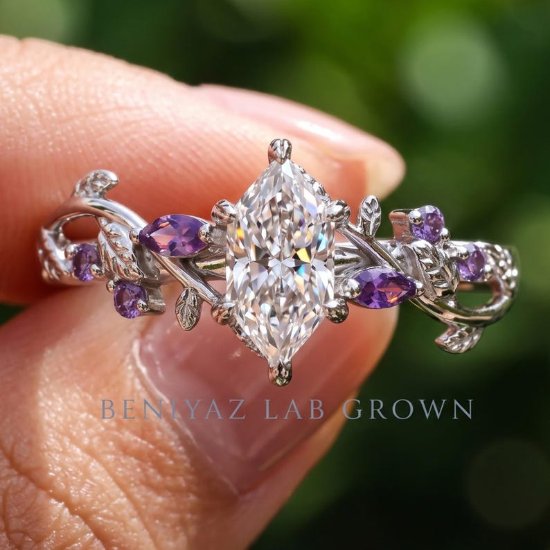 Close up Dutch marquise lab diamond ring with purple Tanzanite accents, leaf details and open botanical setting.
