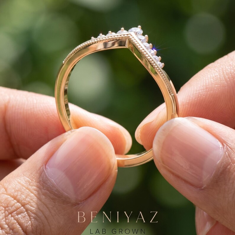 Three quarter view of curved moissanite band showing the contour profile, graduated stones and polished slim shank.