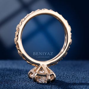Back view of a floral marquise engagement ring showing the carved gold shank and raised center setting.