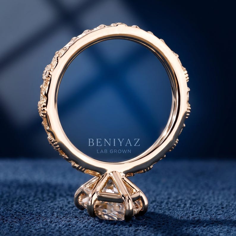Back view of a floral marquise engagement ring showing the carved gold shank and raised center setting.