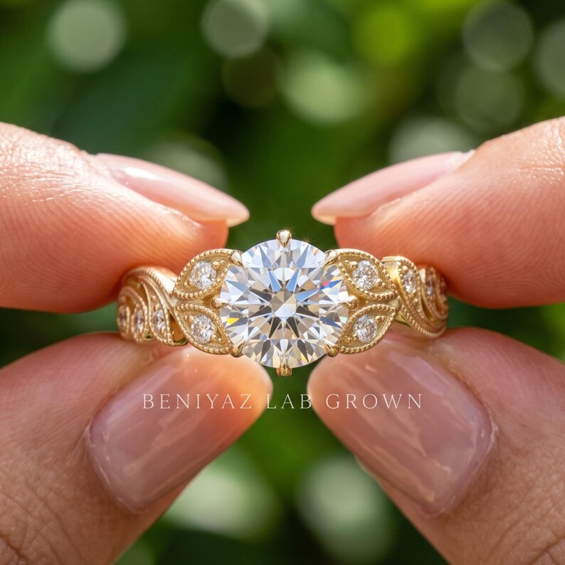 Close up hand view of a yellow gold round lab grown diamond ring featuring a brilliant center stone and side diamond accents against a natural green background