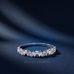 Stackable curved diamond wedding band in white gold with sparkling round and baguette style stones