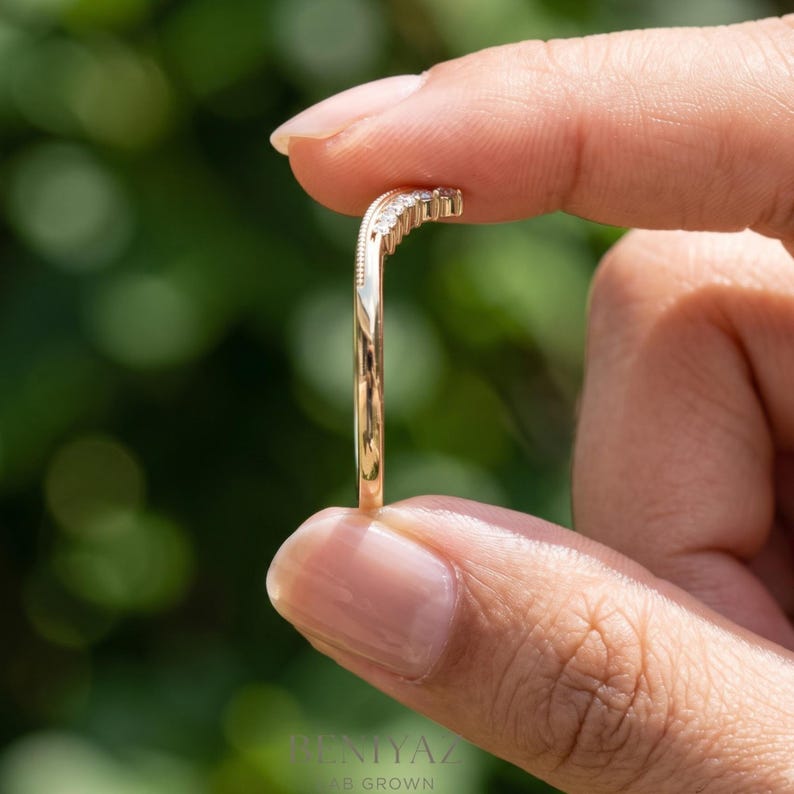 Side profile of moissanite contour ring showing the slim 1.3 mm band and raised curved chevron front.
