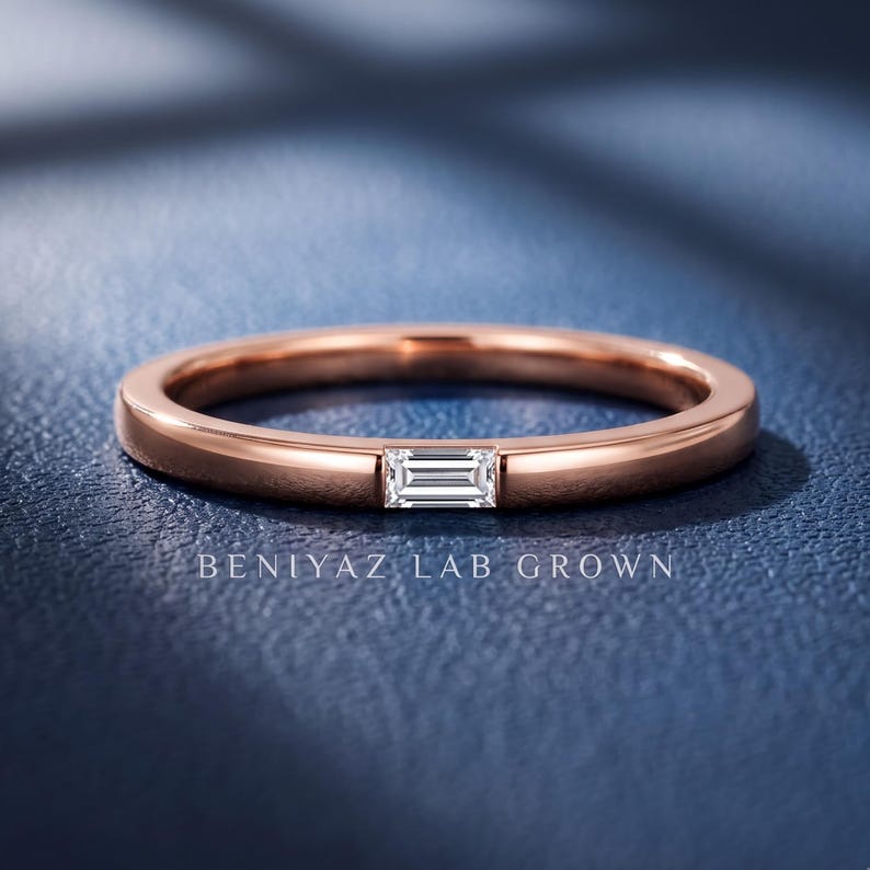 Baguette lab grown diamond wedding band with a single east west bar set stone on a slim polished rose gold band.