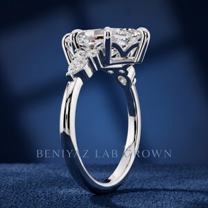 Front close up of marquise lab grown diamond engagement ring with clustered side stones and vintage inspired design