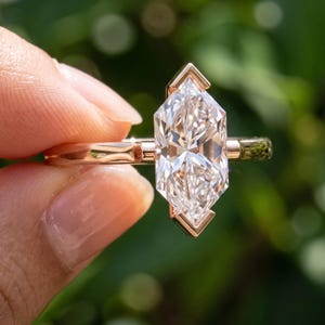 Close side angle of Dutch marquise ring with elongated lab grown diamond center stone and slim minimalist band.