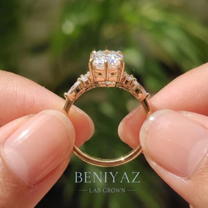 Back view of elongated hexagon diamond engagement ring showing raised prong setting, open gallery and tapered yellow gold shank