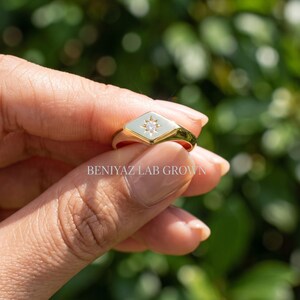 Pinky signet ring side profile with 0.03 CT round cut lab grown diamond and low profile star set center.