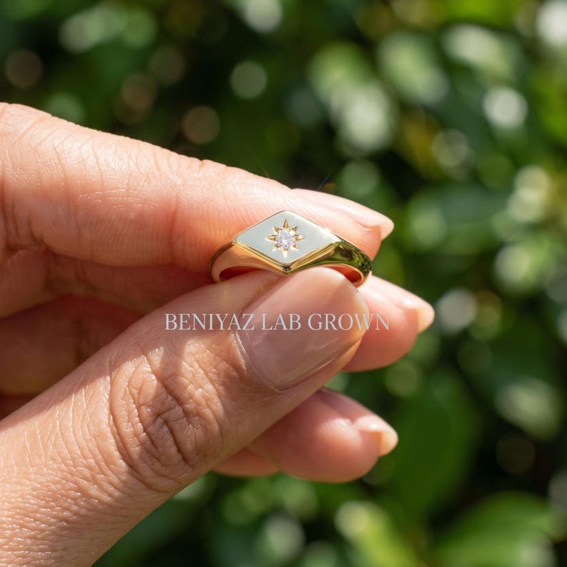 Pinky signet ring side profile with 0.03 CT round cut lab grown diamond and low profile star set center.