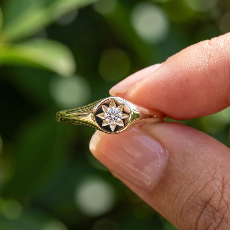 Close up of celestial diamond signet ring with champagne lab grown diamond set in decorative starburst round face