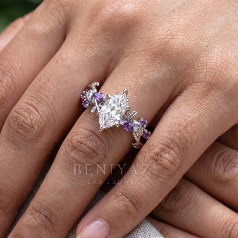 Dutch marquise lab grown diamond engagement ring worn on hand with purple Tanzanite side stones and botanical leaf design.