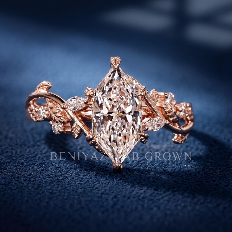 Marquise lab grown diamond engagement ring in rose gold with vintage floral leaf and vine detailing, front close-up view on a deep blue background.
dutch marquise ring
twig engagement ring
rose gold vine ring
woodland engagement ring
branch diamond ring
botanical engagement ring
elvish engagement ring
nature inspired bridal ring
marquise lab grown diamond ring
alternative engagement ring