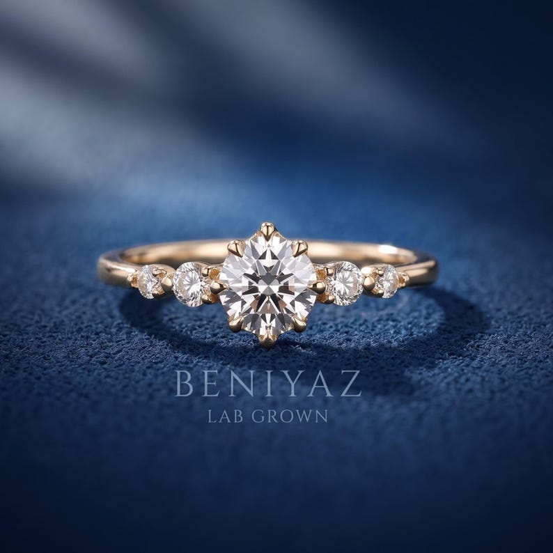Dainty five stone lab grown diamond promise ring in yellow gold with graduated round diamonds and a delicate 1.9 mm thin band, front close-up view.