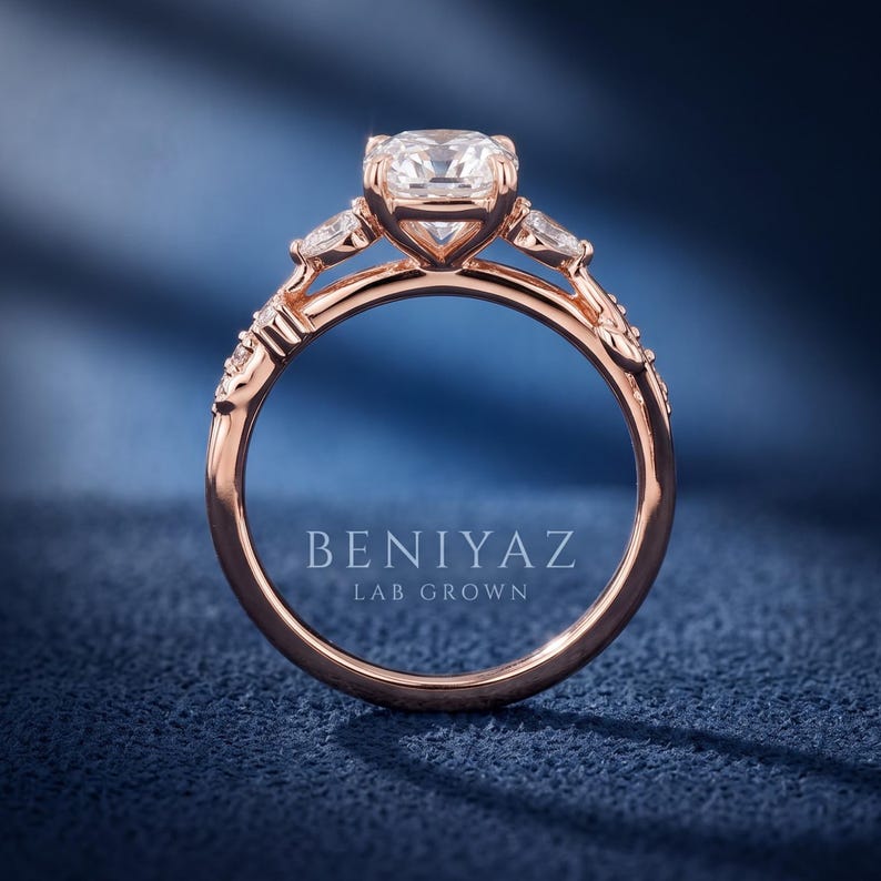 Side profile of a marquise lab grown diamond engagement ring showing the raised centre setting, rose gold band and detailed leaf inspired shoulders.
