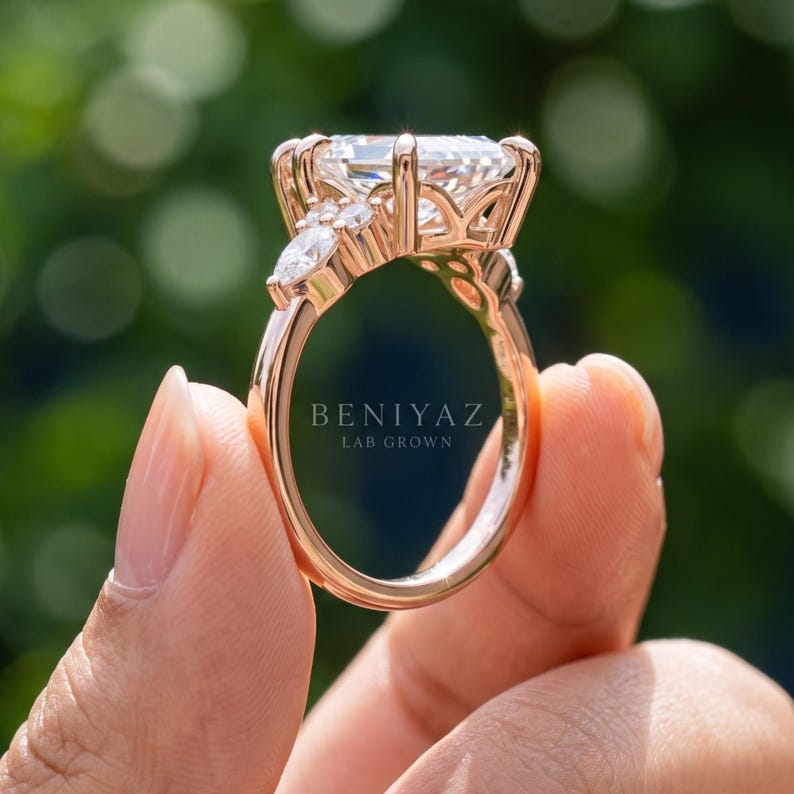 Rear three quarter view of marquise cluster engagement ring showing open gallery arches and side accent stones