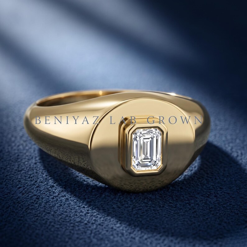 Front studio view of a yellow gold emerald cut diamond signet ring with a single vertical center stone.