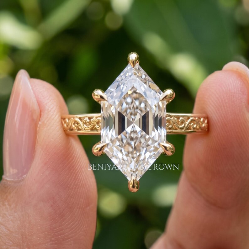 Hand held rear profile of a marquise diamond engagement ring showing the ring shank, gallery and hidden halo construction.