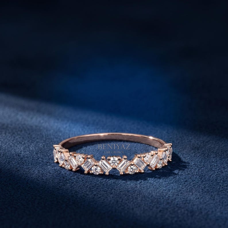 White gold curved diamond band featuring alternating round and emerald cut lab grown diamonds for women
