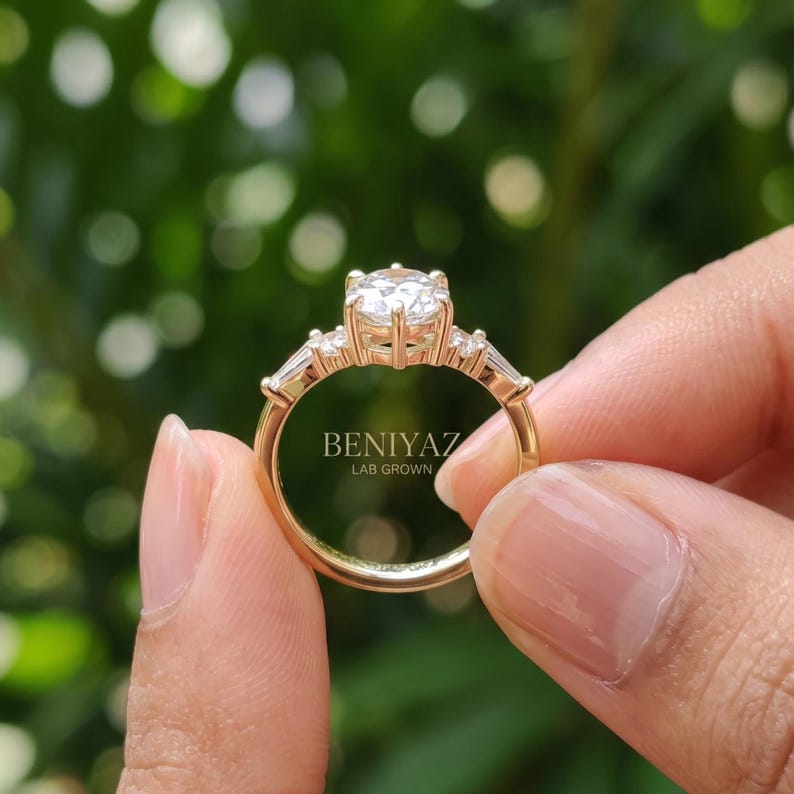 Rear view of hexagon engagement ring held by hand showing tapered shank, open setting and polished yellow gold band