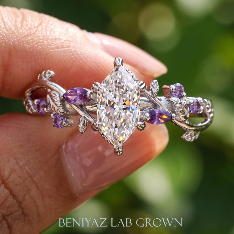 Dutch marquise engagement ring close up showing sparkling lab grown diamond center and purple gemstone leaf vine setting.
