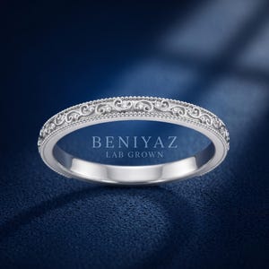 White gold ornate scroll milgrain wedding band with engraved vintage pattern, delicate stackable ring, classic bridal band with antique styling.