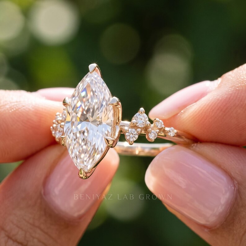 Close front view of lab grown diamond cluster ring with marquise center stone and sparkling vintage inspired side diamonds.