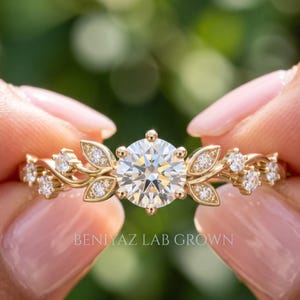 Halloween jewellery
Front close-up of lab grown diamond leaf ring with round brilliant center, botanical vine shoulders and dainty engagement ring design.