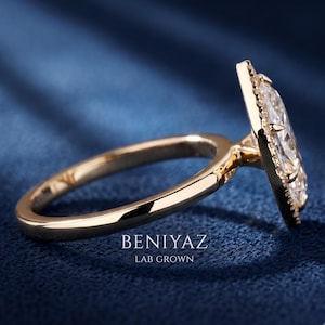 Side profile of a Dutch marquise lab grown diamond halo engagement ring showing the elevated setting, pavé halo and straight gold shank.