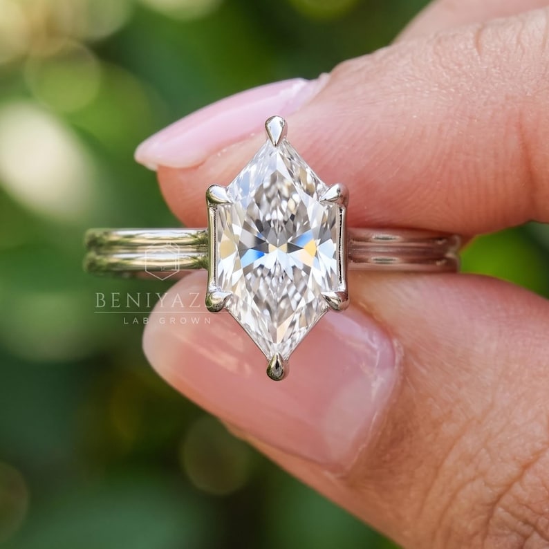 Close-up front view of a Dutch marquise lab grown diamond solitaire engagement ring with F color, VS clarity center stone, elegant six-prong setting and polished double band design. Minimalist bridal jewelry photographed in natural light.