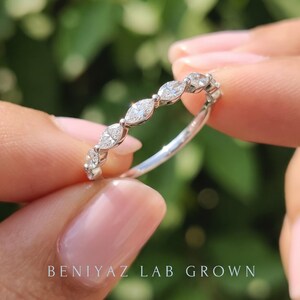 Close up of east west marquise lab grown diamond band with round brilliant diamond accent, stacking ring