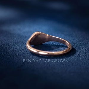 Back and inside view of rose gold tone round signet ring showing tapered band, smooth interior and stone free design