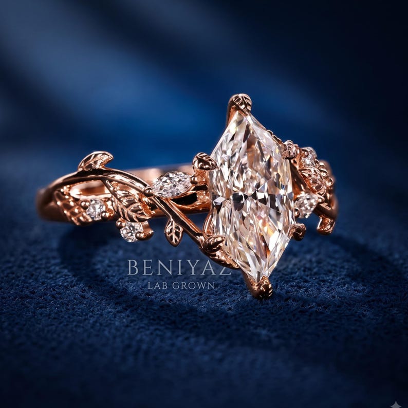 Front hero view of a marquise cut lab grown diamond engagement ring featuring an ornate rose gold floral leaf setting and accent diamonds.