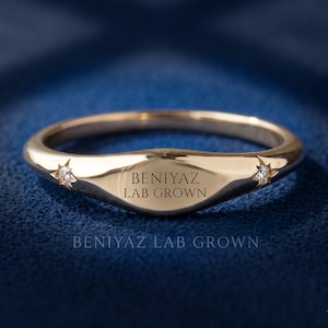 Custom engraved tapered signet ring in yellow gold showing BENIYAZ LAB GROWN text across the polished front face.