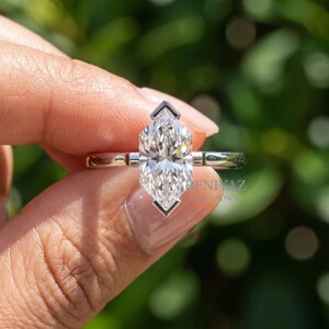 Close front angle of Dutch marquise lab grown diamond ring highlighting the elongated cut, brilliance and V shaped tip prongs.