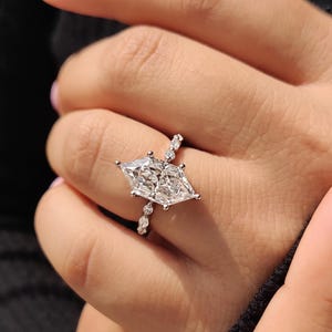 Side view of dutch marquise lab grown diamond solitaire ring showing six prongs and diamond accent band