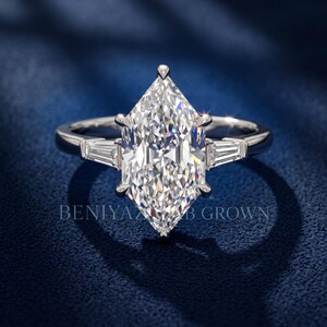 Front studio view of Dutch marquise lab grown diamond engagement ring on blue velvet with elongated 2 carat center stone