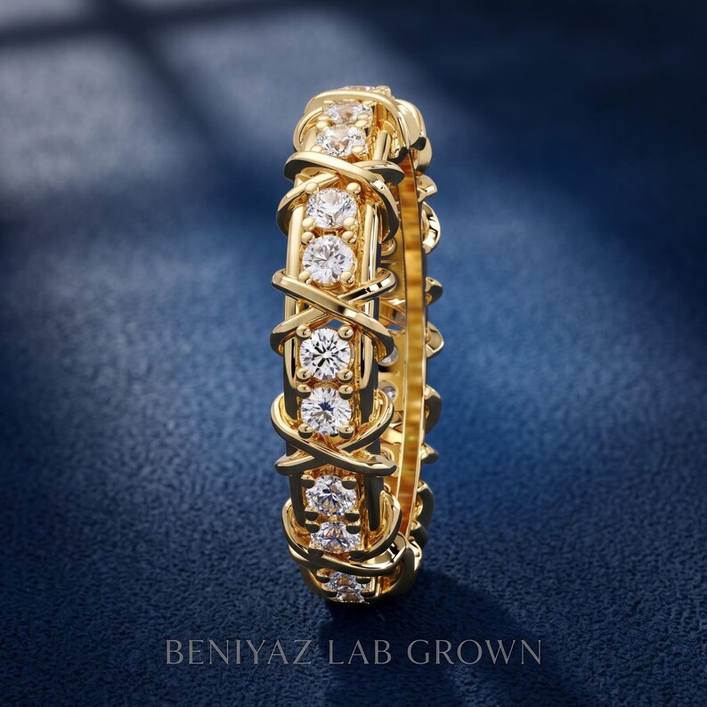 Vertical side view of a full eternity diamond ring highlighting the repeating X crossover design and continuous round diamond setting.