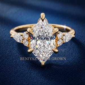 Back view of marquise engagement ring held between fingers showing decorative gallery and smooth polished shank