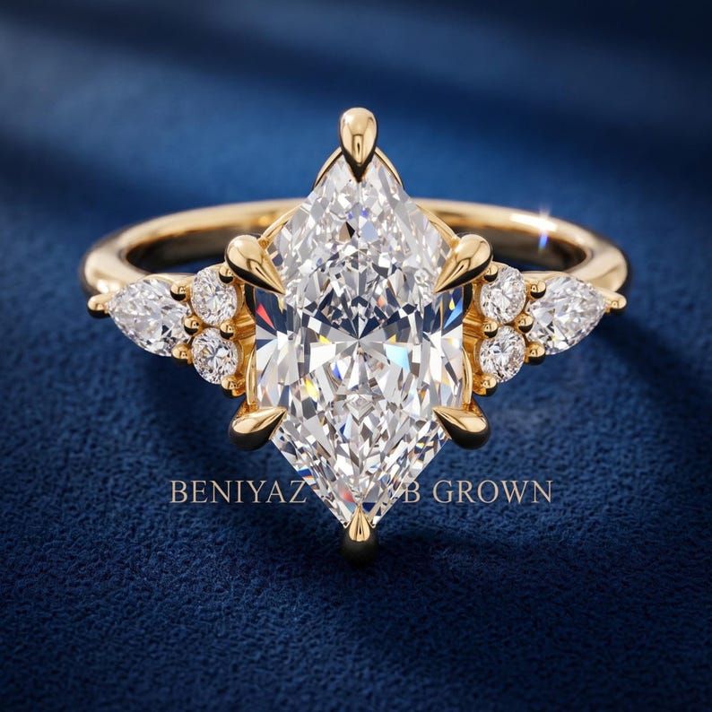 Back view of marquise engagement ring held between fingers showing decorative gallery and smooth polished shank