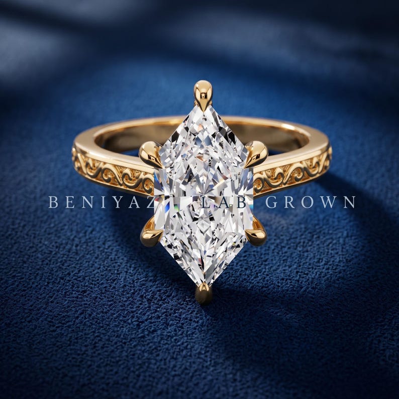 Marquise lab grown diamond engagement ring in yellow gold with hidden halo, six prong setting and vintage filigree band.
