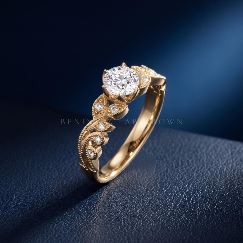 Yellow gold round diamond engagement ring with a brilliant lab grown diamond center, vintage inspired floral leaves, delicate milgrain work and sparkling side stones.