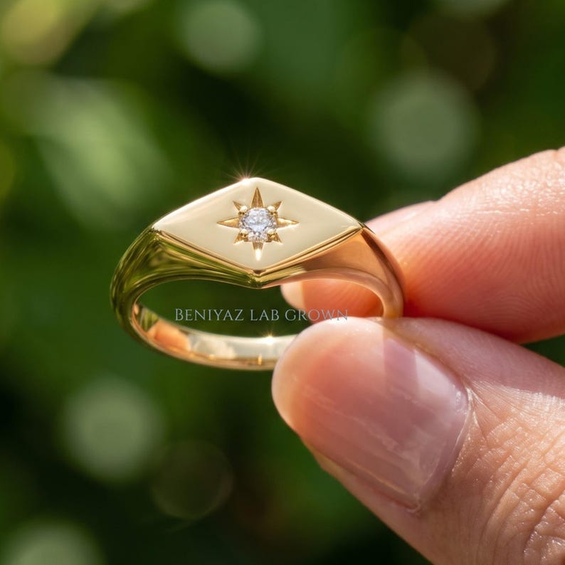 Engagement ring alternative with round lab grown diamond, celestial star setting and modern gold signet ring design.