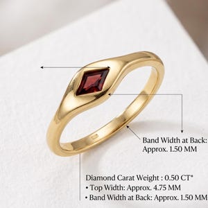 Back view of red gemstone ring showing tapered shank, slim band and smooth high polish gold tone finish.