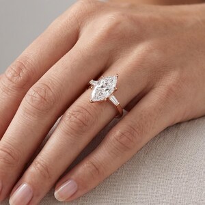 Woman wearing Dutch marquise lab grown diamond engagement ring with elongated center stone in an elegant bridal look