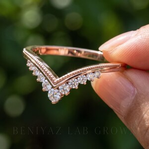 Side front view of V shaped contour ring with graduated moissanite stones and slim polished wedding band.