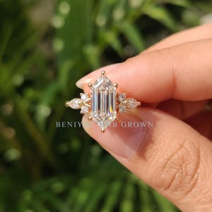 Detailed front view of hexagon cut lab grown diamond engagement ring with symmetrical marquise and round side stones