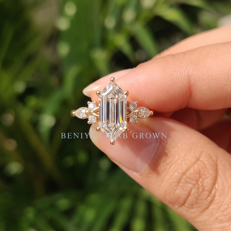 Detailed front view of hexagon cut lab grown diamond engagement ring with symmetrical marquise and round side stones